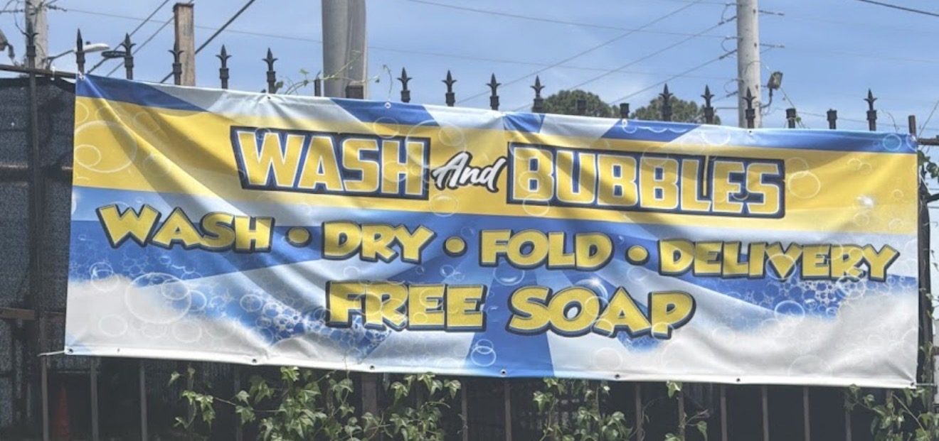 Wash And Bubbles outdoor banner: wash, dry, fold, delivery, free soap
